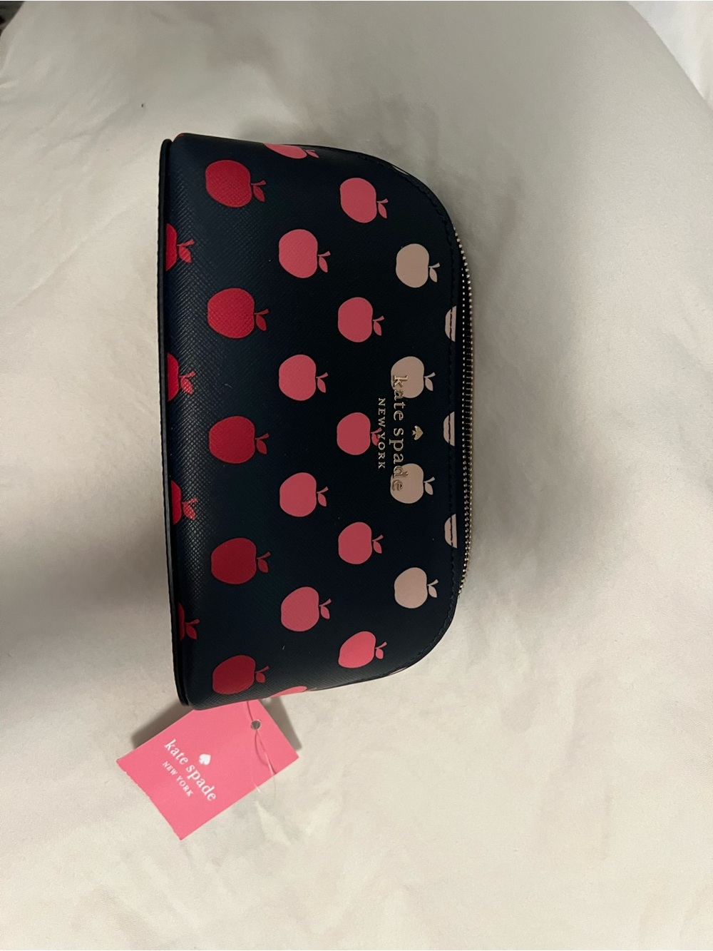 kate spade navy cosmetic pouch with pink and red apple print